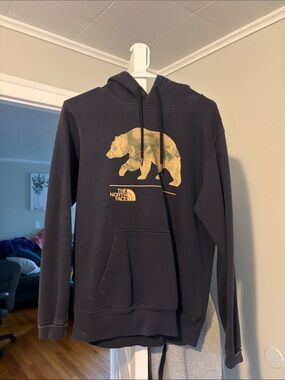 The North Face Black Hoodie with Gold Bear Graphic